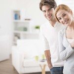 Cheerful couple inviting people to enter in home