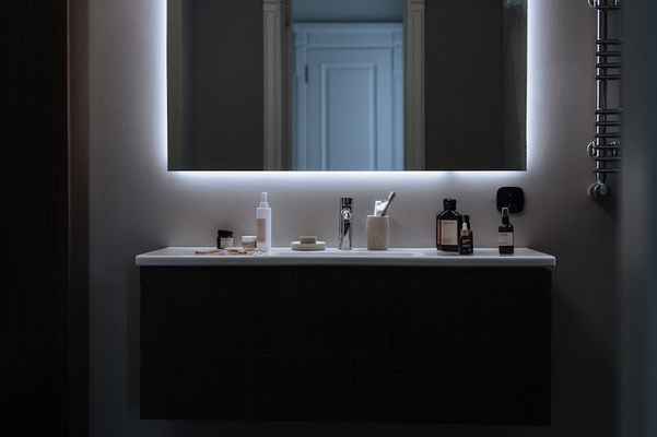a bathroom with a led-lit mirror