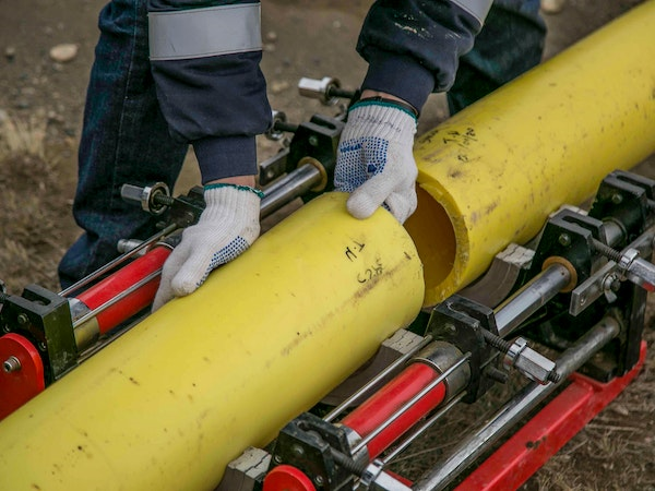 A Person Holding Yellow Pipes