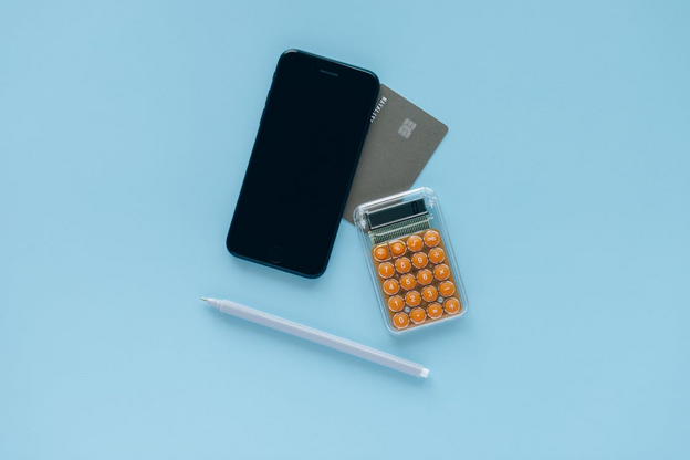 Free Smartphone Beside a Calculator Stock Photo